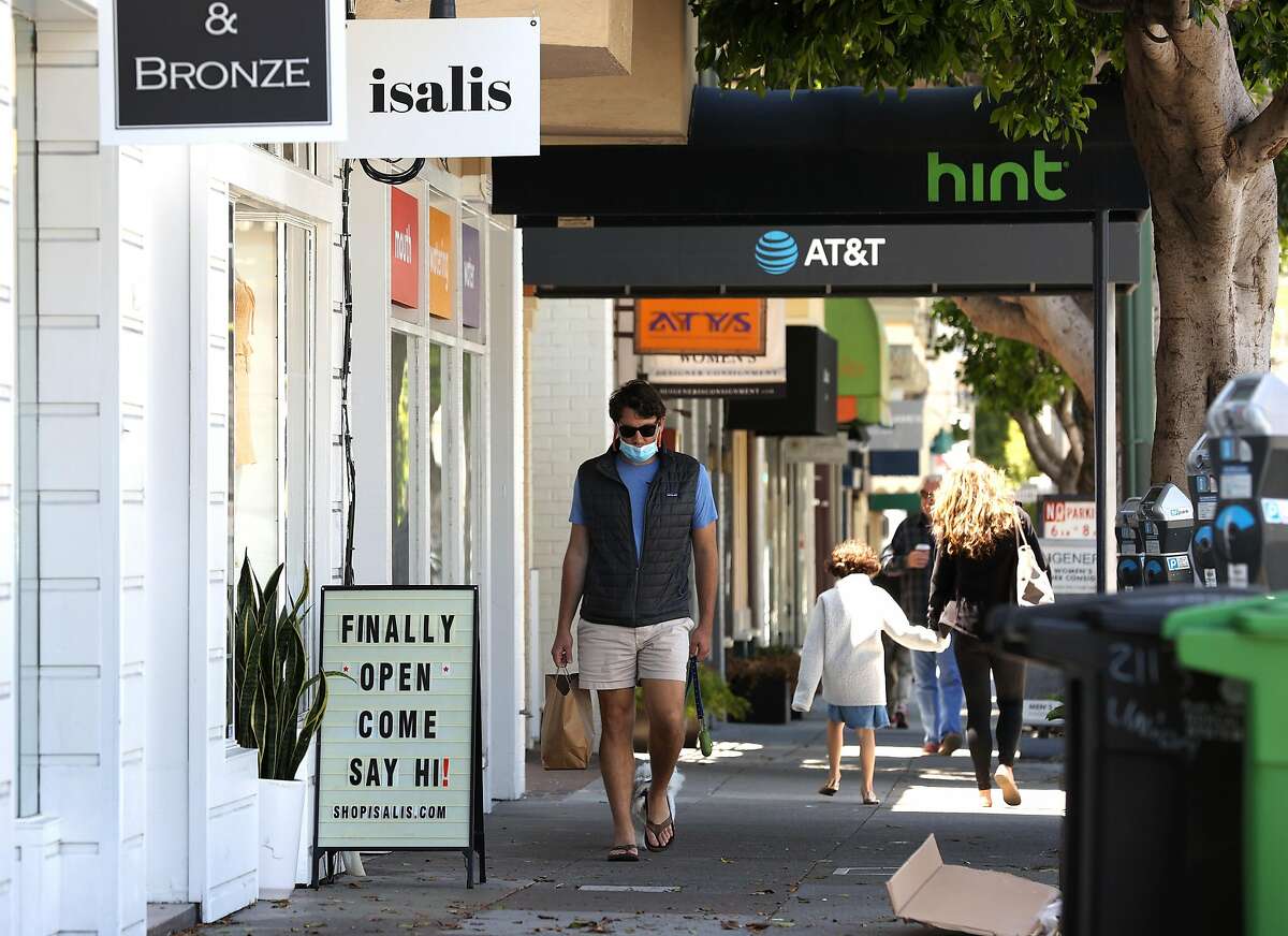 SAN FRANCISCO, CALIFORNIA - JUNE 16: A pedestrian walks by a retail store that has reopened on June 16, 2020 in San Francisco, California. According to a report by the U.S. Commerce Department, retail sales surged 17.7 percent in May as more states begin the process of reopening after being shut down due to the coronavirus COVID-19 pandemic. (Photo by Justin Sullivan/Getty Images)