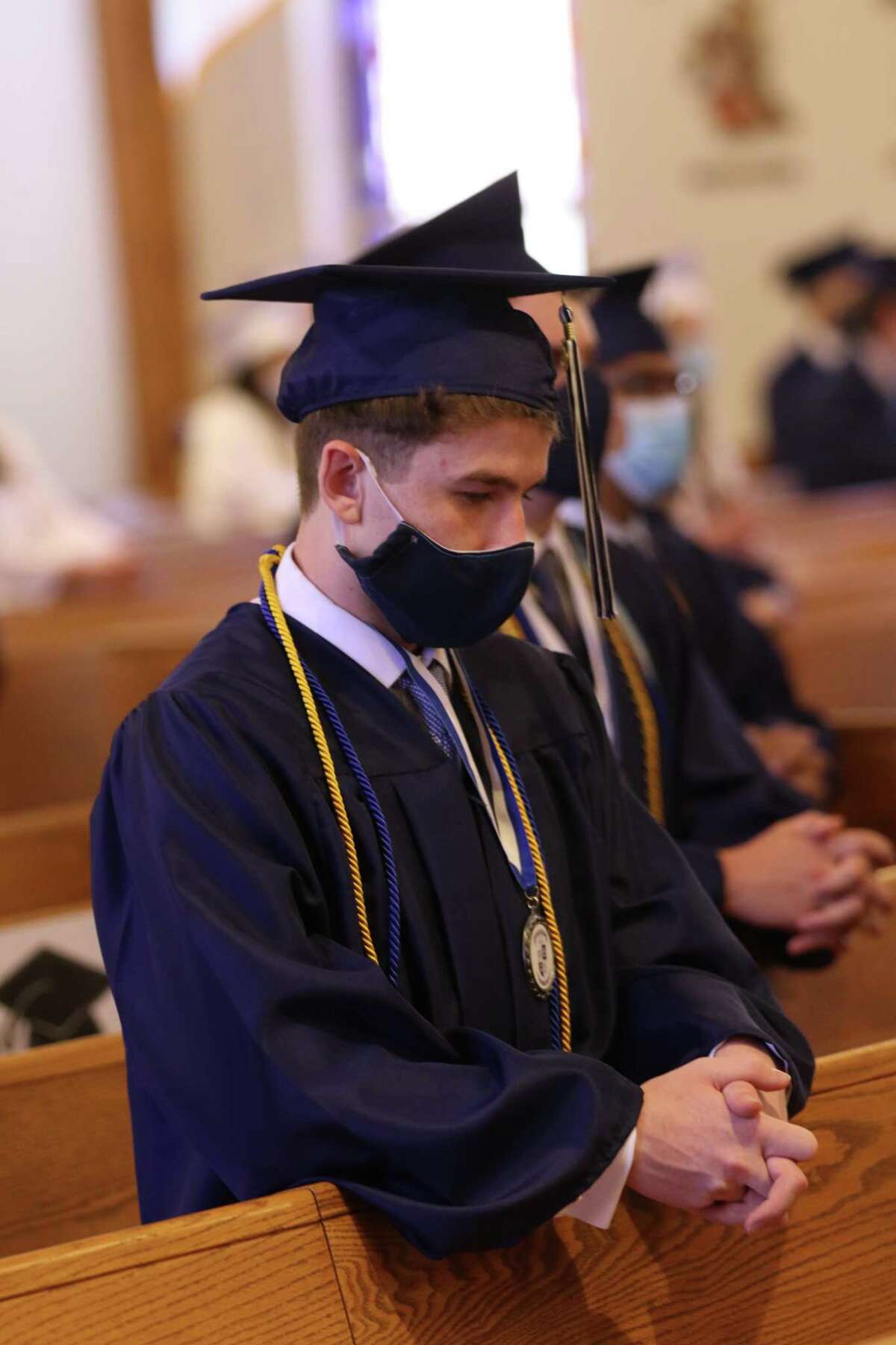 Tristan DiNatale, of Sherman, praying at the IHS Commencement Liturgy on Saturday, June 13 at St Rose of Lima Church in Newtown.