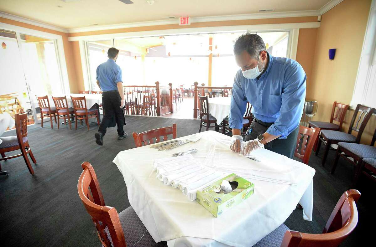 Patrons of Harbor Lights Waterfront Sea House in Norwalk, Connecticut on June 16, 2020 enjoy outdoor dining as the restaurant prepares and shows how it has reconfigured its seating for indoor dining. The new seating arrangement, which will allow patrons to enjoy service from one of 15 tables indoor or the 13 tables available outdoors is part of the restaurant preparation plan for Connecticut's phase two of reopening, set to go into effect Wednesday.