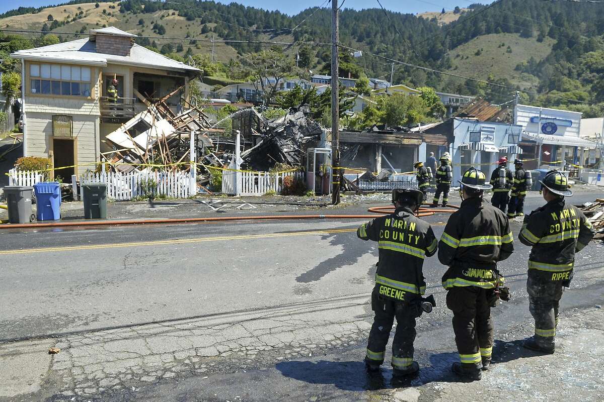 Firefighters work at the scene of a fire, which was preceded by an explosion, in downtown Stinson Beach, Calif. on Tuesday, June 16, 2020. Authorities closed Highway 1 after fire from an explosion spread to multiple buildings Tuesday in a beach community just north of San Francisco. (Alan Dep/Marin Independent Journal via AP)