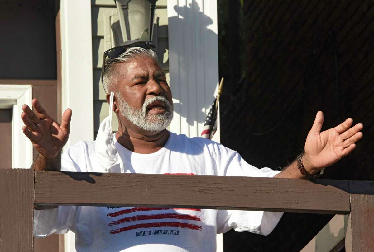 Mohammed Hossain speaks from his front porch to people who gathered in front of his home to greet him after his release from federal prison on Tuesday, June 16, 2020 in Albany, N.Y. Hossain is still in home confinement. A documentary filmmaker has documented Hossain and his co-defendents' stories dealing with FBI informant Shahed Hussain. (Lori Van Buren/Times Union)