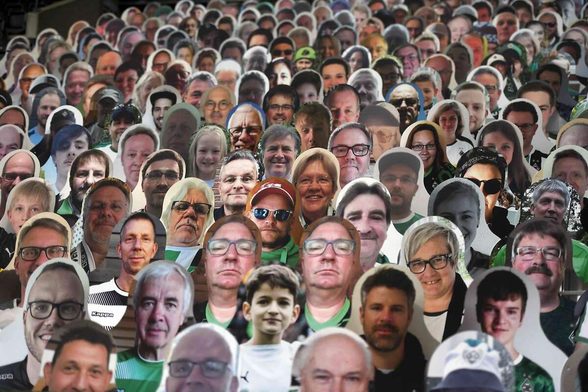 Cardboard pictures of fans are pictures ahead the German first division Bundesliga football match Borussia Moenchengladbach v Bayer 04 Leverkusen on May 23, 2020 in Moenchengladbach, Germany.