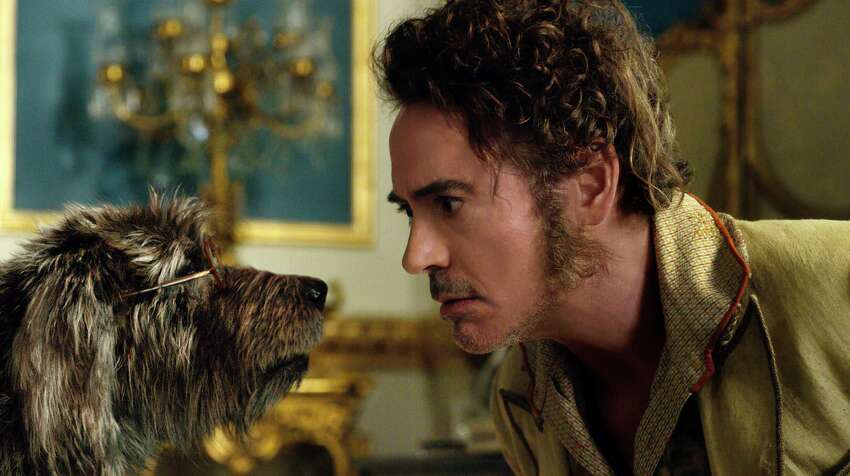 This image released by Universal Pictures shows Dr. John Dolittle, portrayed by Robert Downey Jr., right, with Jip, voiced by Tom Holland, in a scene from 