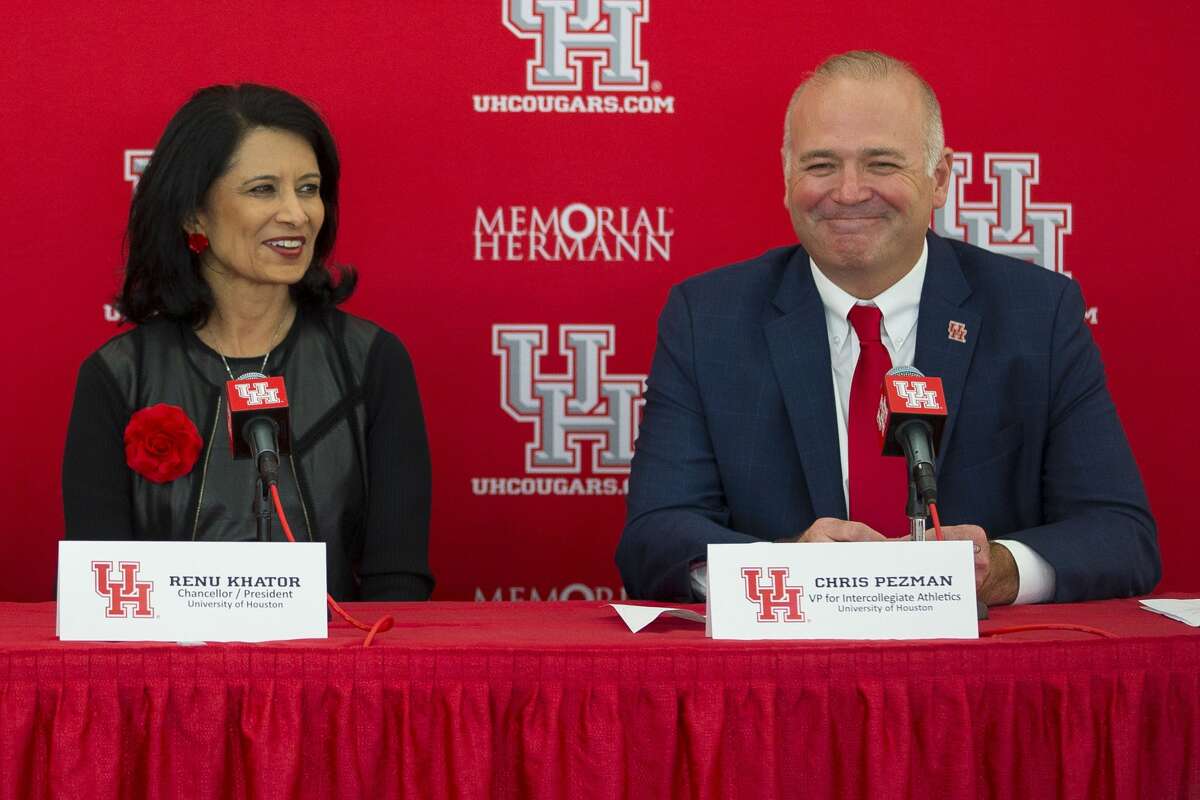 University of Houston president Renu Khator (left) and vice president for intercollegiate athletics Chris Pezman, seen here in happier times, have yet to speak publicly since the school shut down voluntary workouts after six student-athletes tested positive for COVID-19.