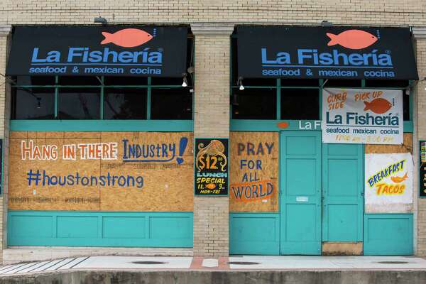 La Fisheria has boarded up its windows with positive messages while still providing togo services Tuesday, April 28, 2020, in downtown Houston.