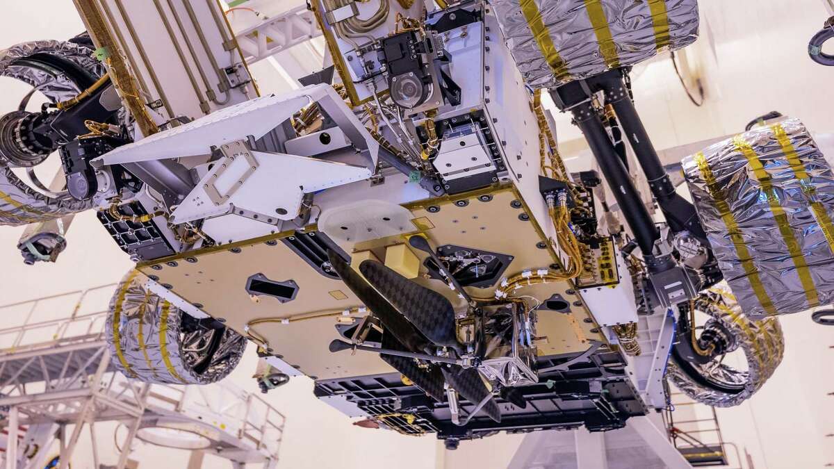 NASA’s Mars Helicopter is installed on the agency’s Mars Perseverance rover inside the Payload Hazardous Servicing Facility at Florida’s Kennedy Space Center on April 6, 2020. After Perseverance lands on Mars on Feb. 18, 2021, the helicopter will be released to perform the first in a series of flight tests that will take place during a period of about 30 days. The helicopter will be the first aircraft to fly on another planet.