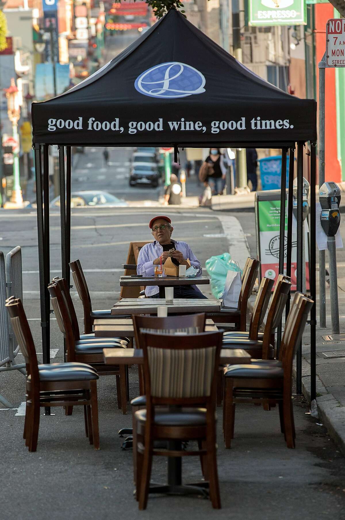 Louis Samuels has dinner at Ideale on Grant Street on outdoor seating in San Francisco, Calif., on Tuesday, June 16, 2020. The transitional post-shelter in place phase of landscape of San Francisco dining establishments is starting. Eateries try to stir back into action, but with a burden of constraints of protecting their customers. Several places on Belden Place are coming back with spaced outdoor tables, and several places on Green Street between Grant and Columbus are testing the waters as well with new dining in the street.