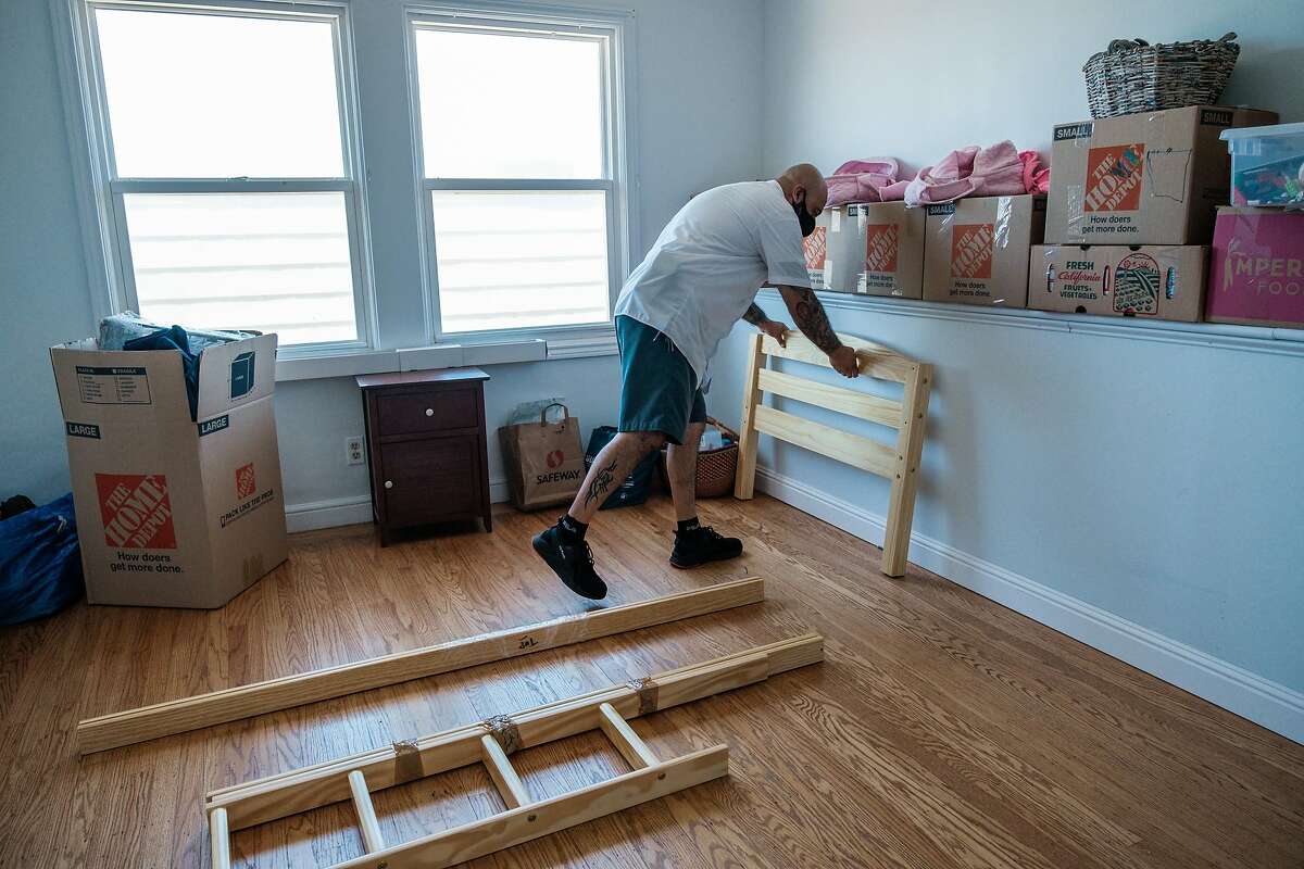 Victor Hernandez with Shamrock Moving and Storage moves a client's belongings into a house in San Francisco on Wednesday, June 17, 2020.