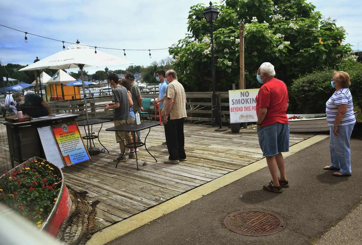 A line of customers wait to be seated for outdoor dining on the first day of Phase II reopening at Joey C's Boathouse in Stratford, Conn. on Wednesday, June 17, 2020. The restaurant only plans on seating customers indoors during inclement weather.