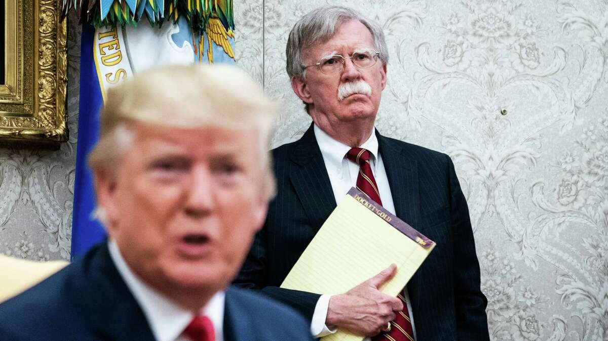 John Bolton, the national security adviser at the time, listens to President Donald Trump during an Oval Office meeting in July 2019.