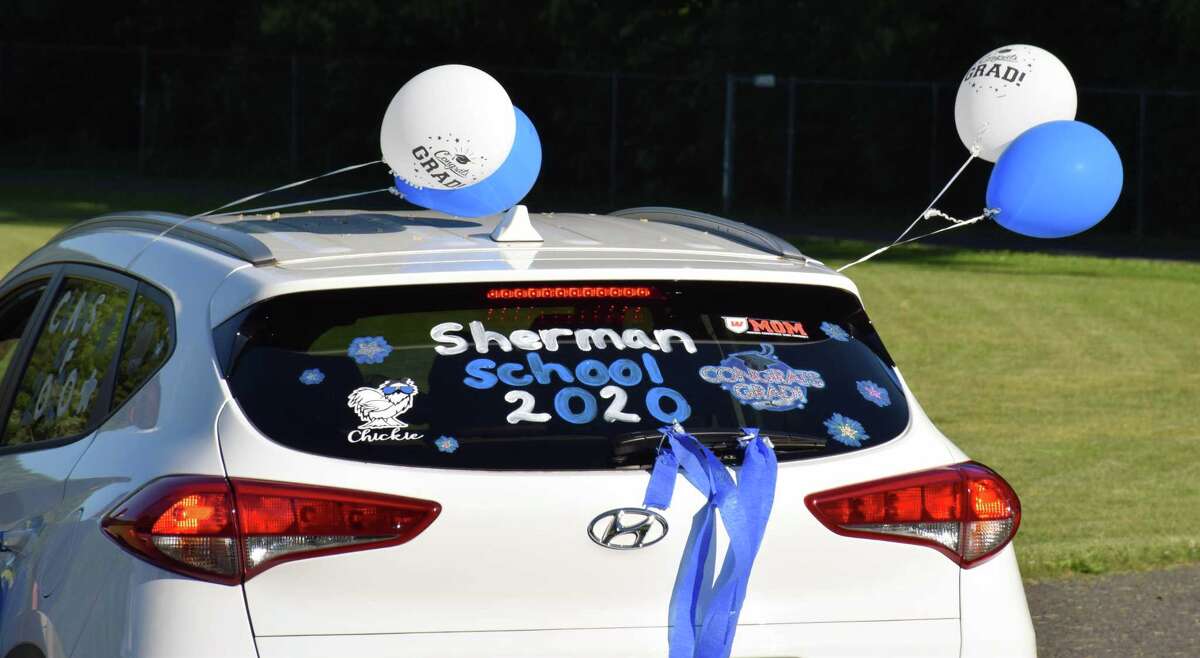Decorations adorn a vehicle for one of the graduates.