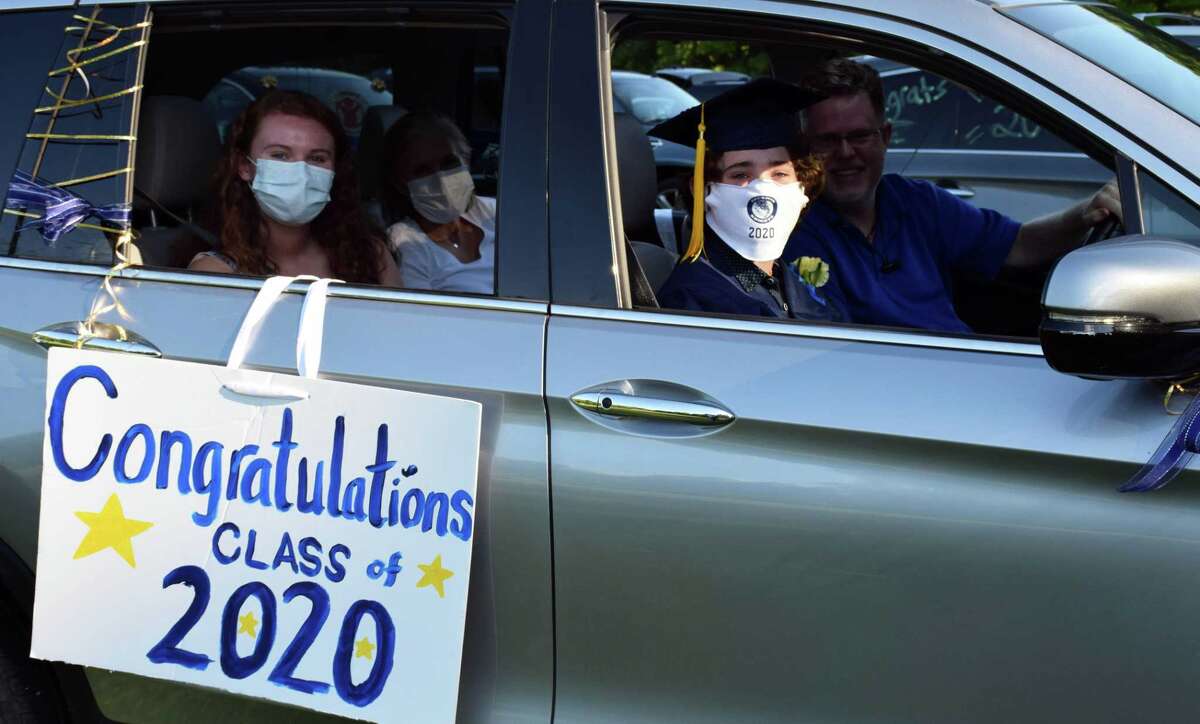 Spectrum/Sherman School held its eighth-grade graduation ceremony June 13, 2020 at Veterans Field. Students arrived in a vehicle, decorated for the occasion, filled with family and friends and parked at the field, where a ceremony was held adhering to social distancing guidelines. Above, graduate Quinn Delamere is joined by his family members, Kiernan, Stacey and Katherine, in their car as they wait for the start of the ceremony.