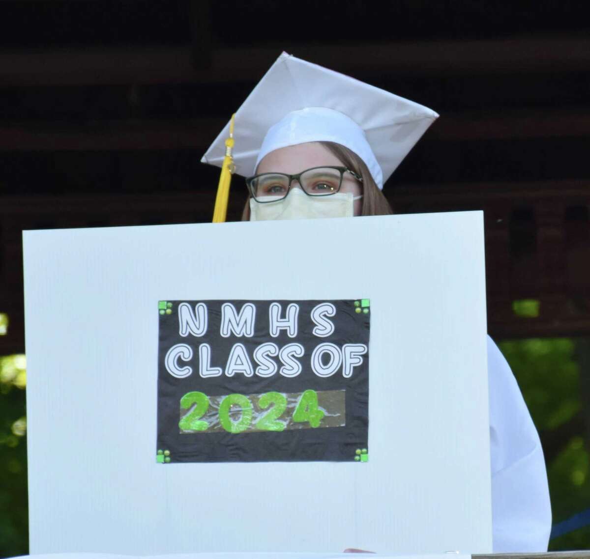 Spectrum/Sherman School held its eighth-grade graduation ceremony June 13, 2020 at Veterans Field. Students arrived in a vehicle, decorated for the occasion, filled with family and friends and parked at the field, where a ceremony was held adhering to social distancing guidelines. Above, Katherine Devine holds up a sign showing her classmates where she will be heading to in the fall, New Milford High School.