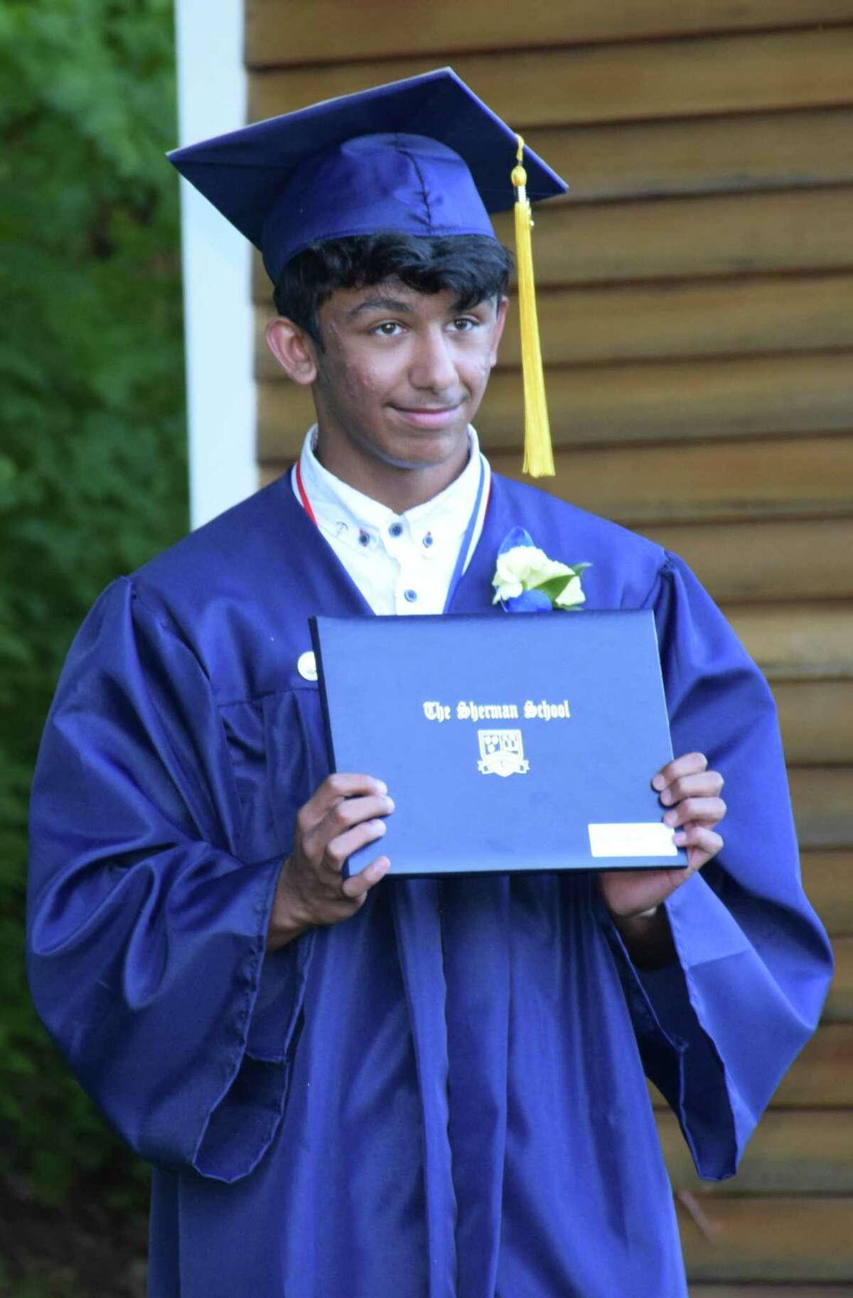 Spectrum/Sherman School held its eighth-grade graduation ceremony June 13, 2020 at Veterans Field. Students arrived in a vehicle, decorated for the occasion, filled with family and friends and parked at the field, where a ceremony was held adhering to social distancing guidelines. Above, Aidan Mendell poses for a professional photograph after receiving his certificate.