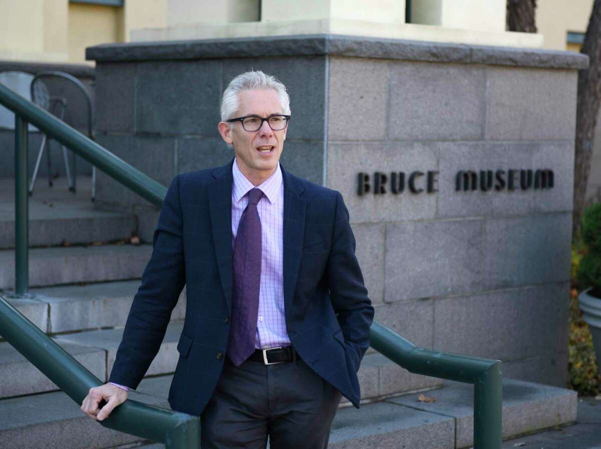Bruce Museum Executive Director and CEO Robert Wolterstorff poses at the entrance of the Bruce Museum in Greenwich, Conn. Tuesday, Nov. 26, 2019. The New Bruce $60 million renovation will add state-of-the-art exhibition, education and community spaces, and dramatically enhance the art and science collections as well as a new cafe. The campaign includes $45 million for design and construction and, to ensure sustainability, $15 million for the museum’s endowment.