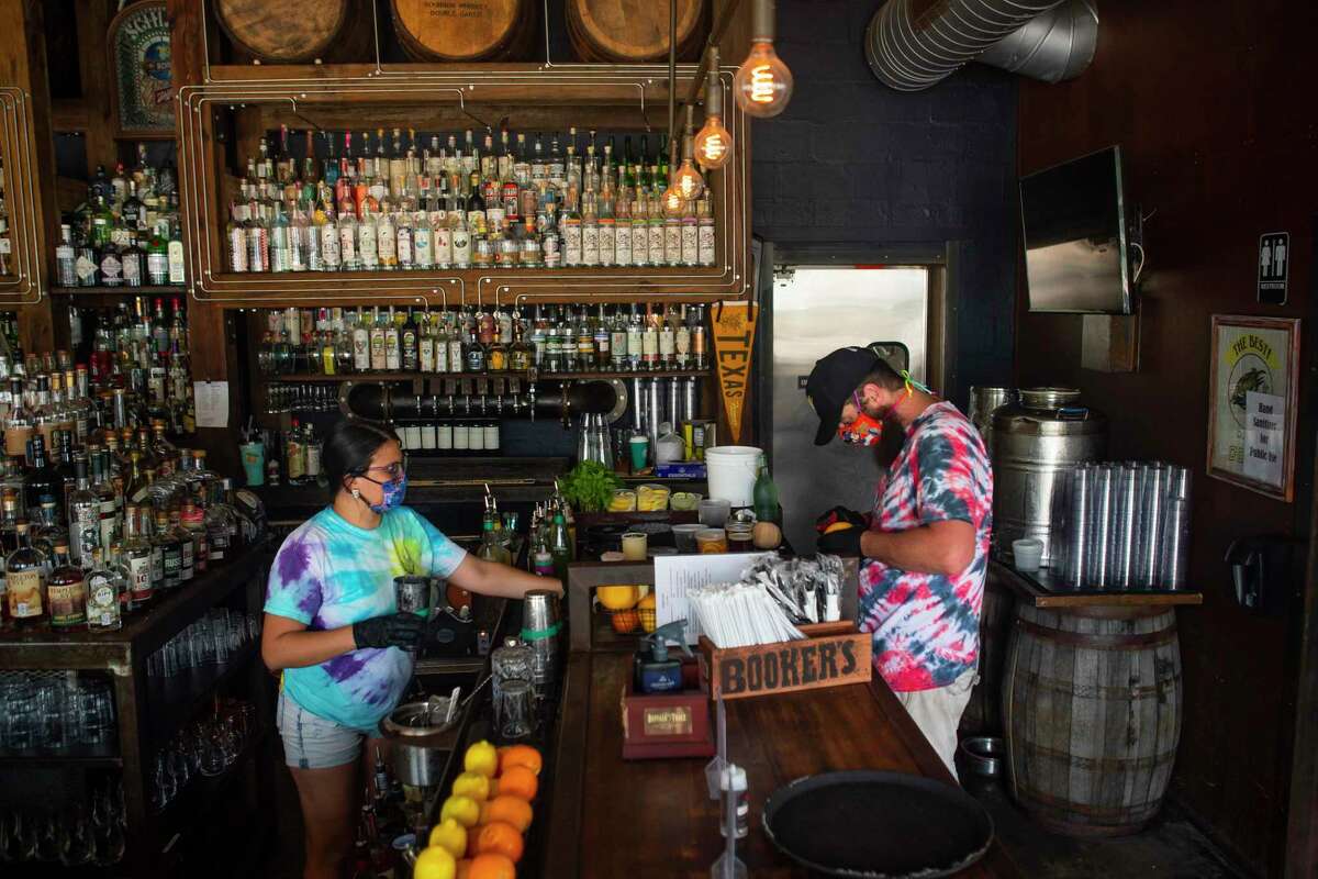 Bartender Melise Rodriguez (left) and server Josh Keating prepare drinks, Friday, May 22, 2020, at Eight Row Flint in Houston.