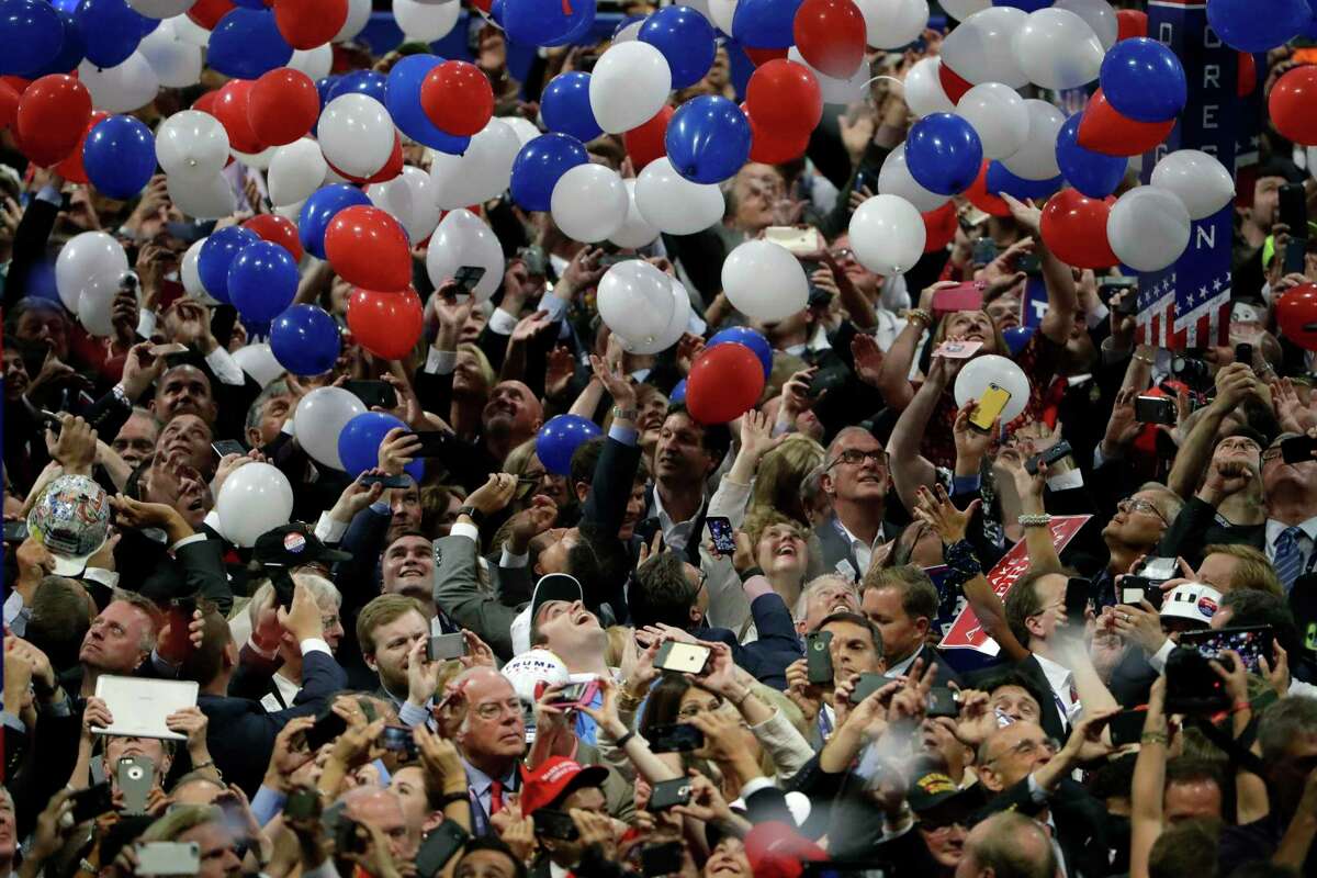 In this July 21, 2016, file photo, confetti and balloons fall during celebrations after Republican presidential candidate Donald Trump's acceptance speech on the final day of the Republican National Convention in Cleveland. Not visible in this photo are germs. One reason a reader is glad the RNC is not coming to San Antonio in this time of COVID-19.