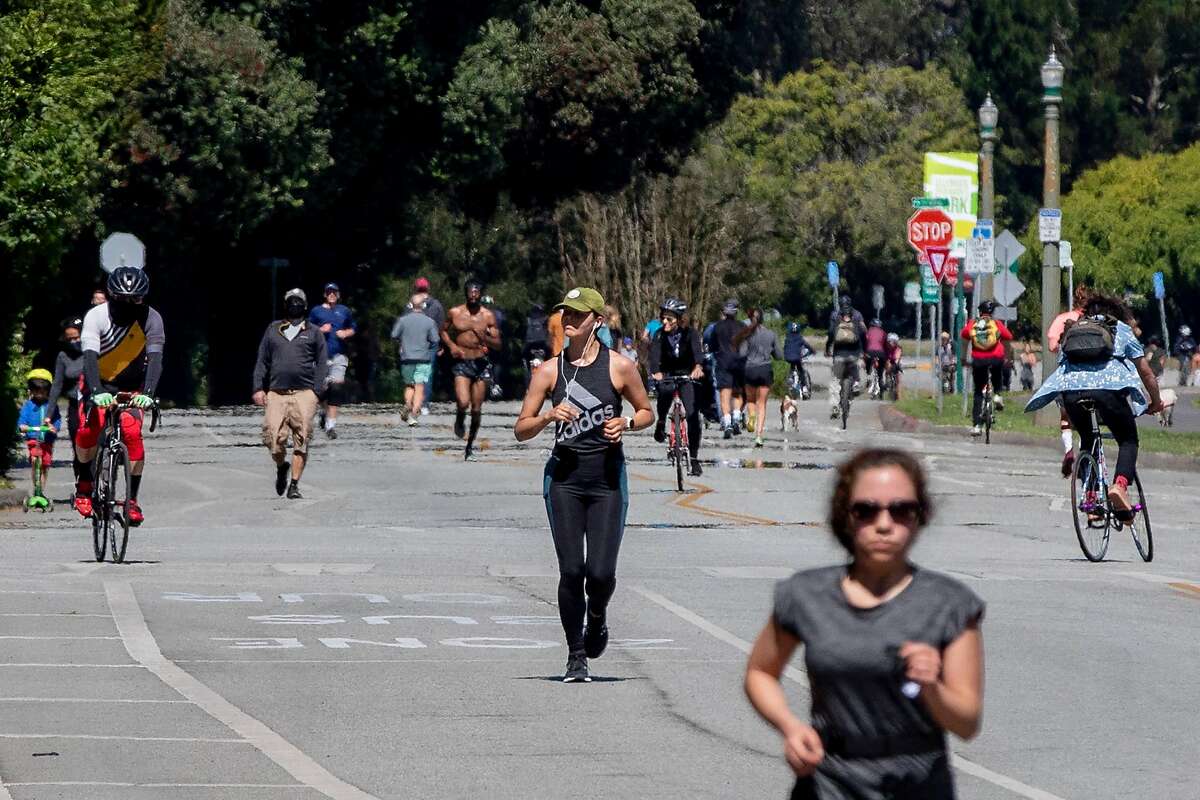Runners, bikers and walkers move down John F. Kennedy Drive through Golden Gate Park in San Francisco, Calif. Saturday, June 13, 2020. Shelter-in-place rules in various counties across the Bay Area have began to ease up, giving residents more flexibility with their outdoor activities such as having "social bubbles" of no more than twelve others.