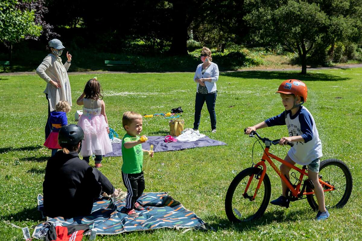 Friends and family socially distance as they gather to celebrate Addie McLaughlin's 6th birthday at Golden Gate Park in San Francisco, Calif. Saturday, June 13, 2020. Shelter-in-place rules in various counties across the Bay Area have began to ease up, giving residents more flexibility with their outdoor activities such as having "social bubbles" of no more than twelve others.