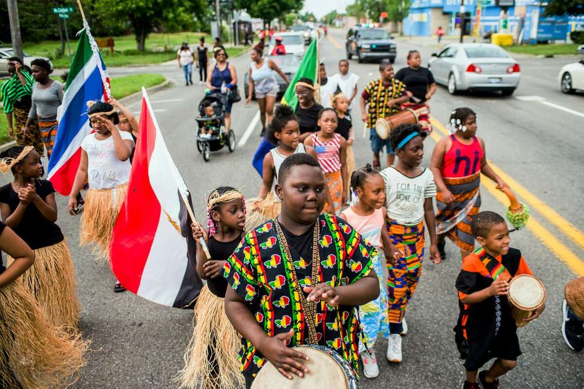 In this June 19, 2018, file photo, Zebiyan Fields, 11, at center, drums alongside more than 20 kids at the front of the Juneteenth parade in Flint, Mich. Juneteenth celebration started with the freed slaves of Galveston, Texas. Although the Emancipation Proclamation freed the slaves in the South in 1863, it could not be enforced in many places until after the end of the Civil War in 1865.