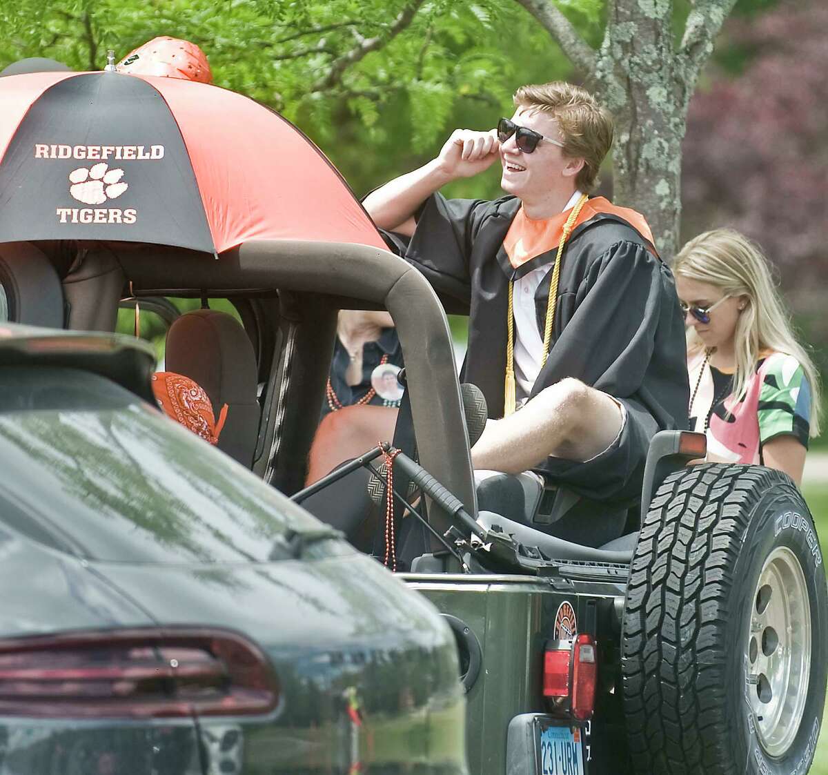 2020 Ridgefield High School graduate John Briody watches the ceremony on the big screen from his Jeep. Thursday, June 18, 2020.