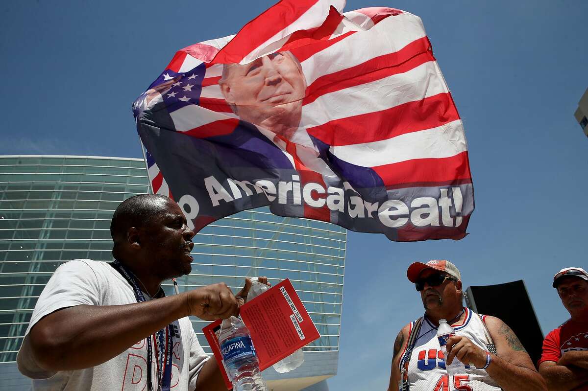 Nicholas Winford (left) debates Trump supporter Randall Thom (right), on the racial policies of U.S. President Donald Trump outside the BOK Center June 18, 2020 in Tulsa, Oklahoma. Trump is scheduled to hold his first political rally since the start of the coronavirus pandemic at the BOK Center on Saturday while infection rates in the state of Oklahoma continue to rise.