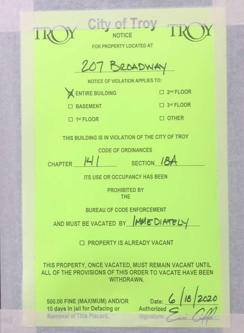 The city-ordered closure notice on Clark House in Troy. The buildings houses restaurants, a market and a bar. (Provided photo.)