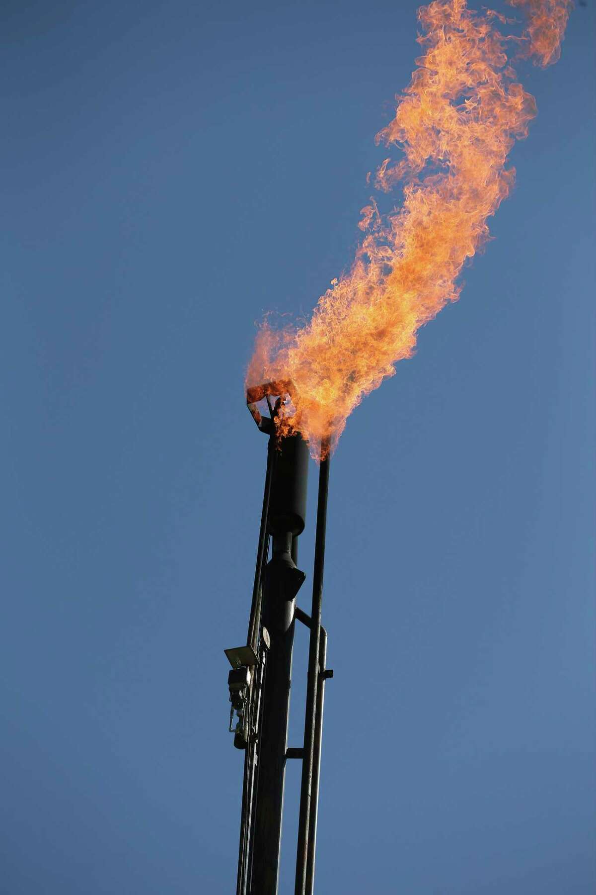 A flaring stack burns off natural gas at an oil extraction site operated by Recoil Resources near Poth, Texas on Monday, Apr. 13, 2020. Recoil Resources and other small oil producers are struggling and are facing a plan to cut production by 20 percent if approved by the Railroad Commission. The commission is scheduled to vote on the matter on Tuesday.