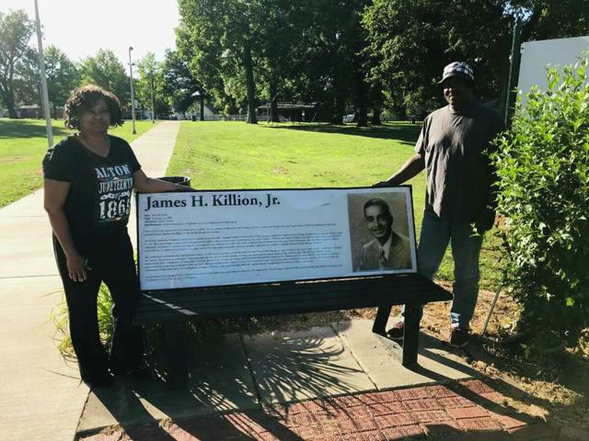 Alton Juneteenth Celebration committee member Marquato Rattler, left, and chairman Lee Barham, both of Alton, stand beside the namesake bench at James H. Killion Park at Salu, at Washington and Salu streets, in Alton. Each year the Alton Juneteenth Celebration is held at the park.