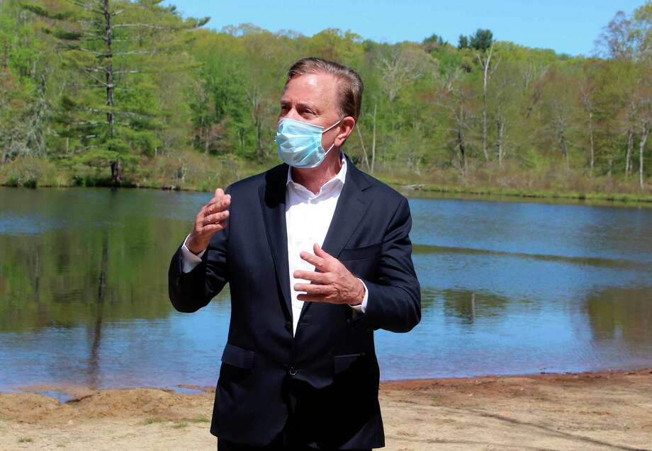 FILE - In this May 21, 2020, file photo, Connecticut Gov. Ned Lamont speaks to reporters at Gay City State Park in Hebron, Conn., updating the coronavirus situation in the state. A bipartisan group of Connecticut legislators gave the governor a list of issues to be reviewed in an upcoming, independent third-party investigation into the preparation and response to the coronavirus inside nursing homes and assisted living centers. (AP Photo/Pat Eaton-Robb, File) Photo: Pat Eaton-Robb / Associated Press / Copyright 2020 The Associated Press. All rights reserved.