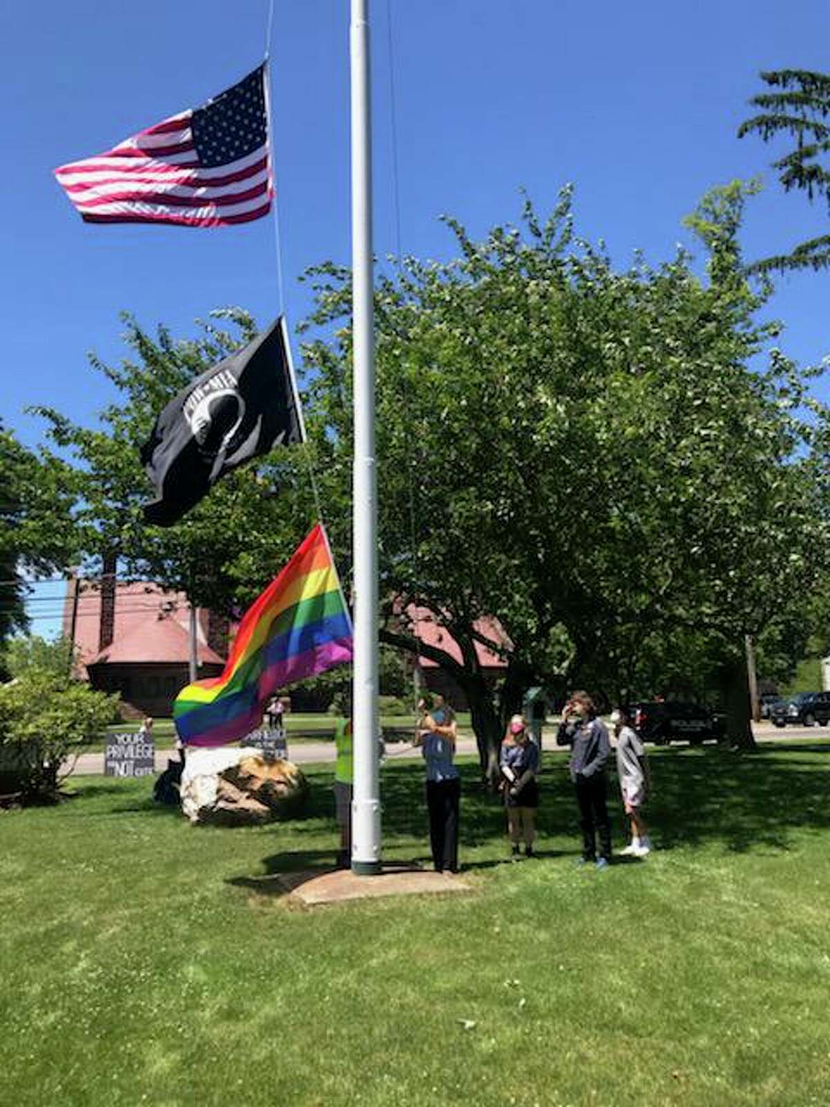 First Selectwoman Brenda Kupchick, Cole Pedro, Willow McKinnis and Jake Banquer raised the pride flag over the Old Town Hall on Wednesday.