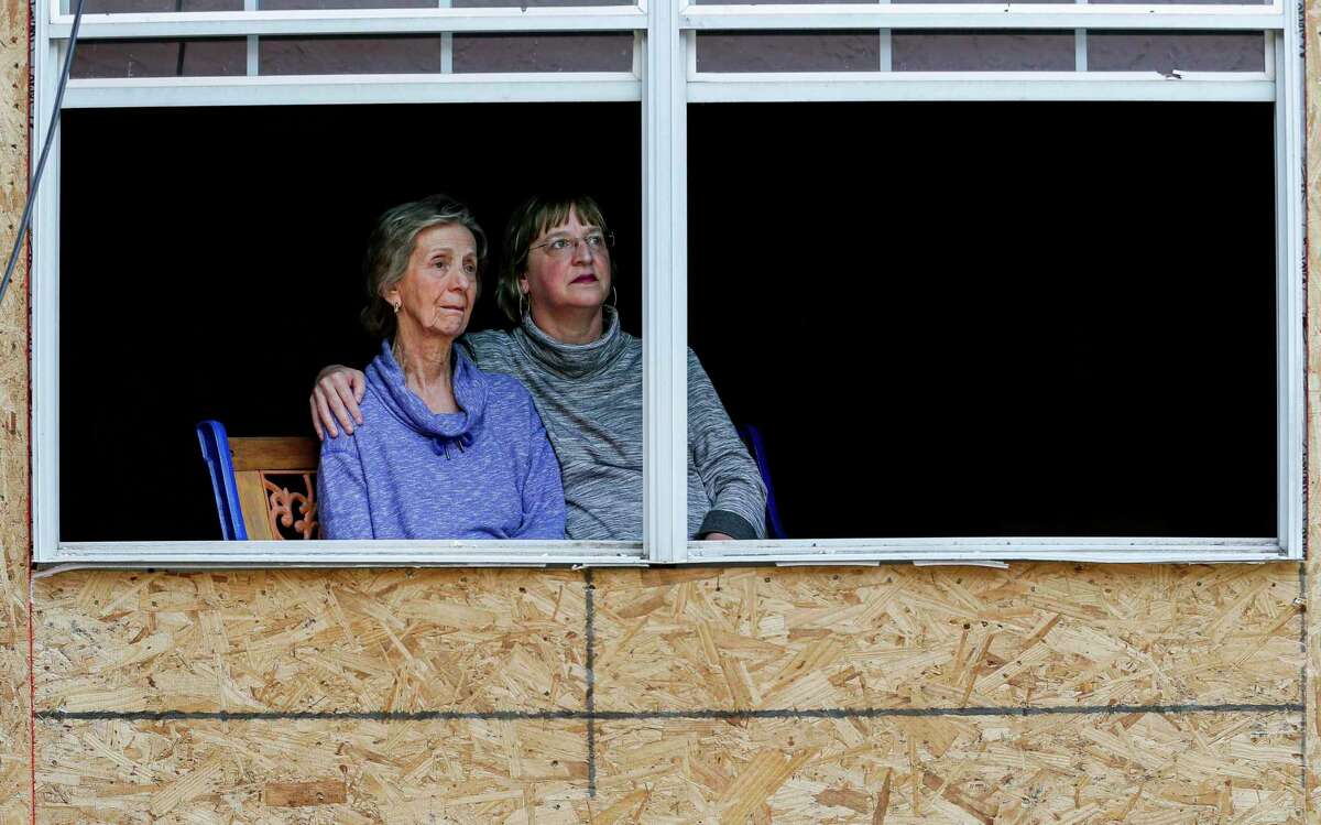 Tracy Stephenson, right, and her mother, Karon Maples, pose for a photograph inside their home, which is being rebuilt after it was knocked off its foundation by an explosion at nearby Watson Grinding and Manufacturing earlier this year, on Thursday, May 7, 2020, in Houston.