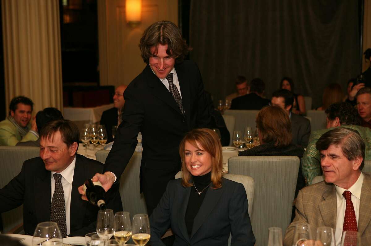 Richard Betts (standing) pours wine for guests (left to right) Dominique Lafon, Deborah Senior and George Borst at the La Poulee de San Francisco 2008 -- a celebration of burgundy wine where 50 elite guests will taste the newest releases and older vintage wines of the growers from over twenty five of the most sought after domaines of Burgundy. The event was held Thursday, Feb. 27, 2008 at the Westin St. Francis in Michael Mina's restaurant. Thor Swift For The San Francisco Chronicle