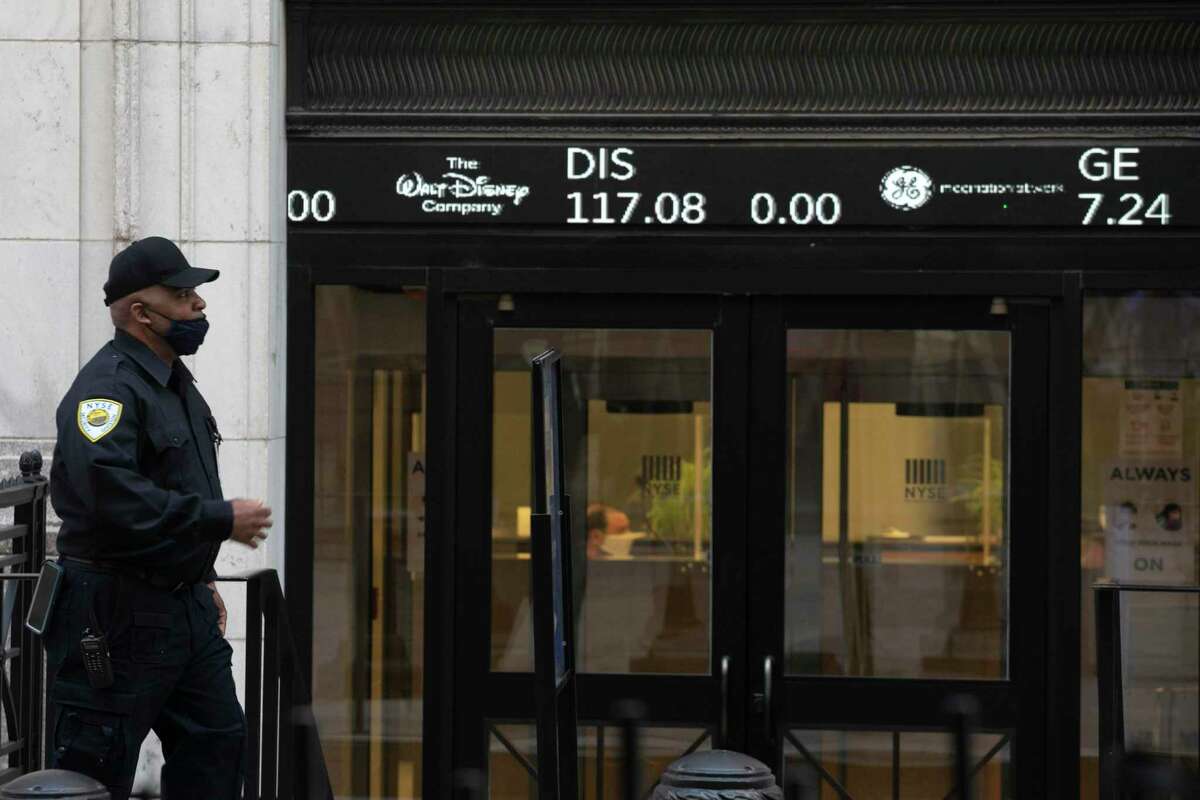 A security guard walks by a stock ticker on the front door of the New York Stock Exchange on Tuesday, June 16, 2020. A recent study measured whether our personal appetite for risk changes, or whether our perception of external risk changes. The results weren’t what we’d expect, columnist Michael Taylor writes.