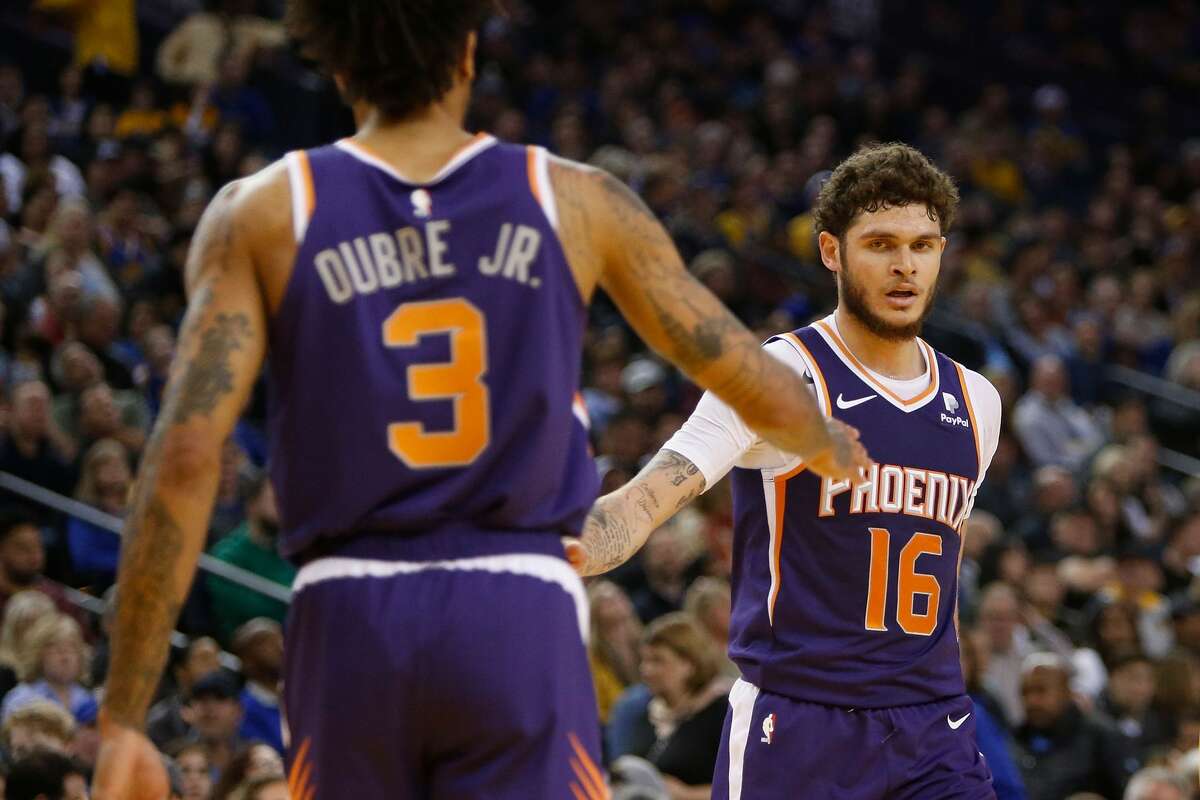 OAKLAND, CA - MARCH 10: Tyler Johnson #16 and Kelly Oubre Jr. #3 of the Phoenix Suns react after a play against the Golden State Warriors at ORACLE Arena on March 10, 2019 in Oakland, California (Photo by Lachlan Cunningham/Getty Images)