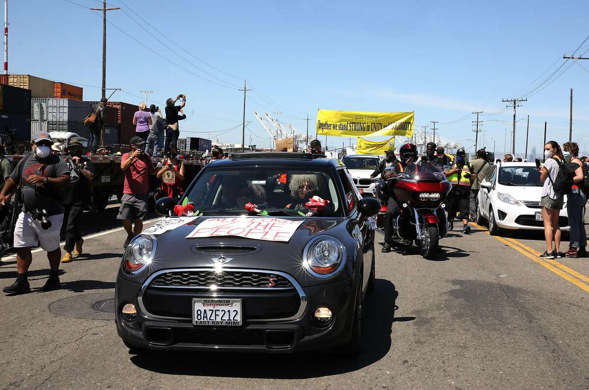 Civil rights icon Angela Davis and her partner Professor Gina Dent ride in their vehicle along Adeline St. while participating in a Juneteenth protest against police brutality as longshoremen shut down the Port of Oakland and 28 other ports along the west coast on Friday, June 19, 2020, in Oakland, Calif.