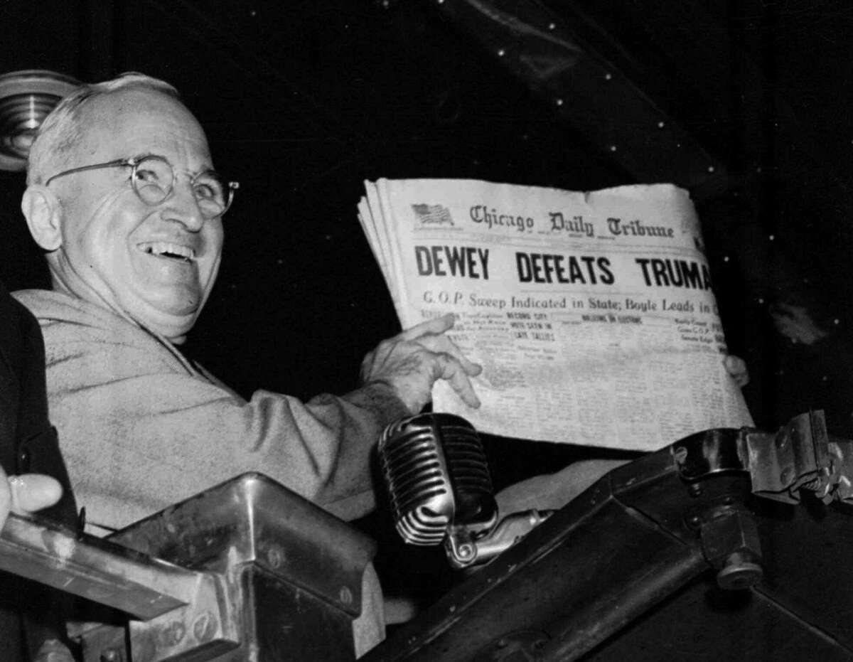 U.S. President Harry S. Truman holds up an Election Day edition of the Chicago Daily Tribune, which, based on early results, mistakenly announced "Dewey Defeats Truman" in this Nov. 4, 1948 file photo. It was the first presidential election that Velia Salinas worked. Decades later, COVID-19 has disrupted that tradition.
