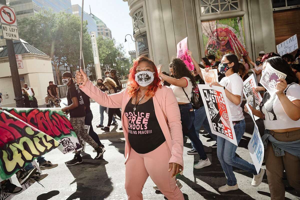 Jessica Black, organizing director with the Black Organizing Project, marches down Broadway with other protesters during a "Black and Brown Solidarity March" put on by the Black Organizing Project and Communities United for Restorative Youth Justice(CURYJ), in Oakland, Calif, on Wednesday, June 17, 2020.