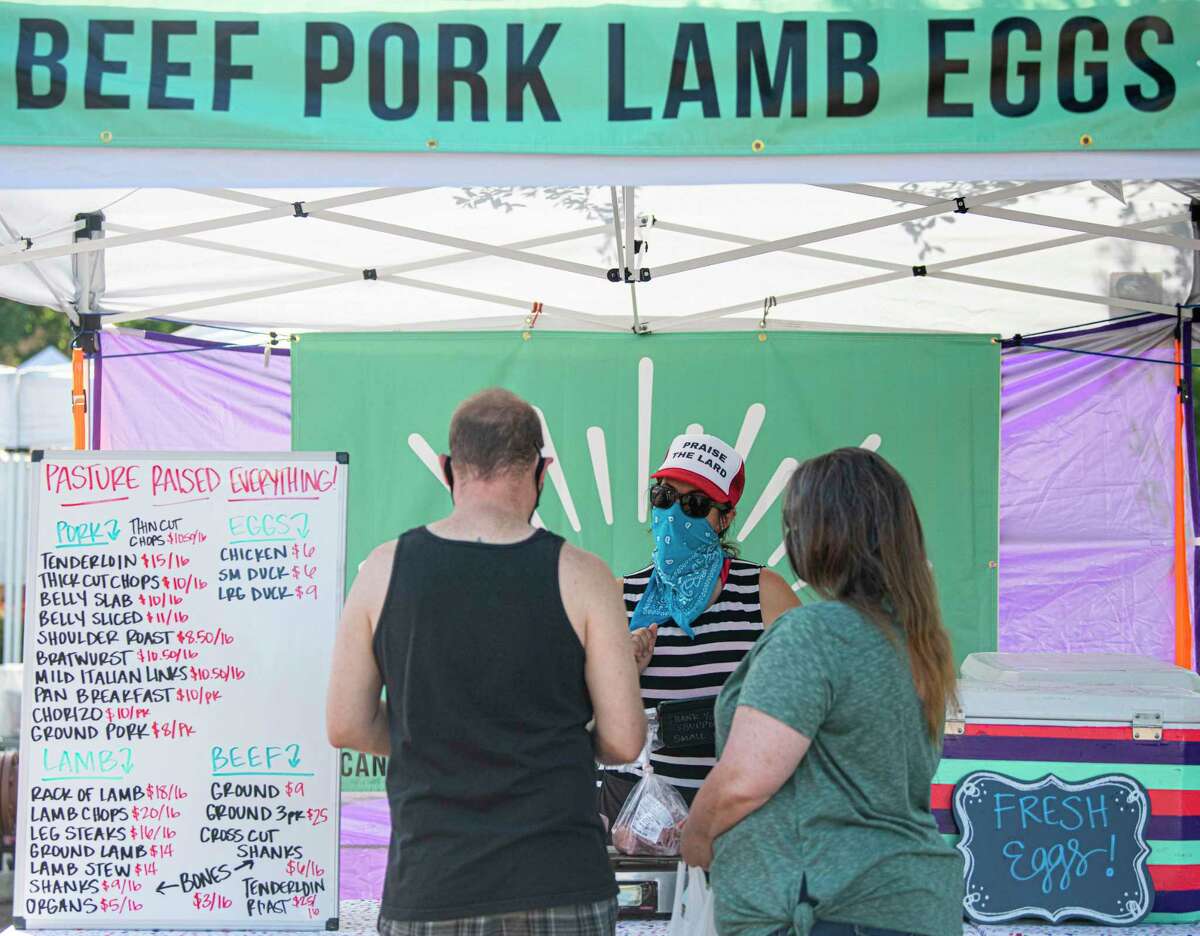 Pure Pastures owner Maggie Eubank sells meats during the Pearl Farmers Market. She is one of many local meat suppliers to report an increase in business due to soaring meat prices at local grocery stores.