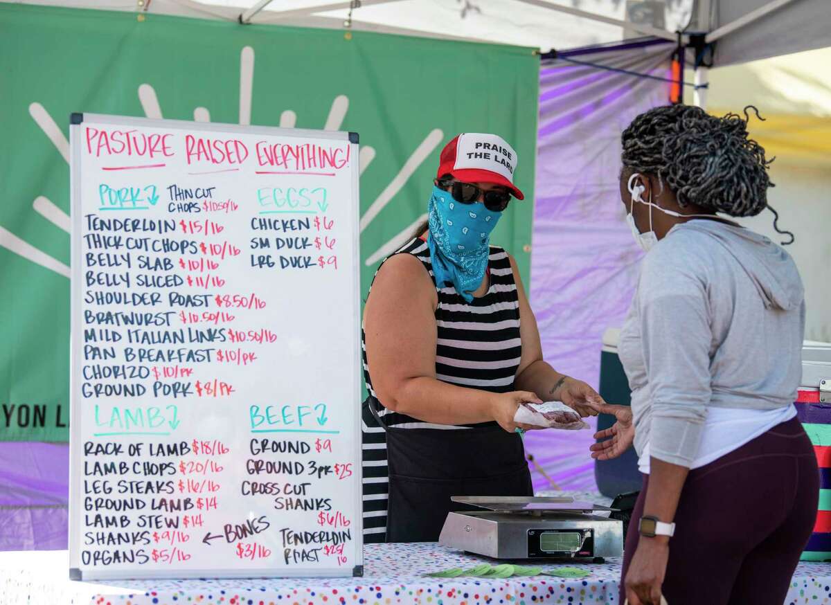 Pure Pastures owner Maggie Eubank sells meats during the Pearl Farmers Market. She is one of many local meat suppliers to report an increase in business due to soaring meat prices at local grocery stores and the need to socially distance.