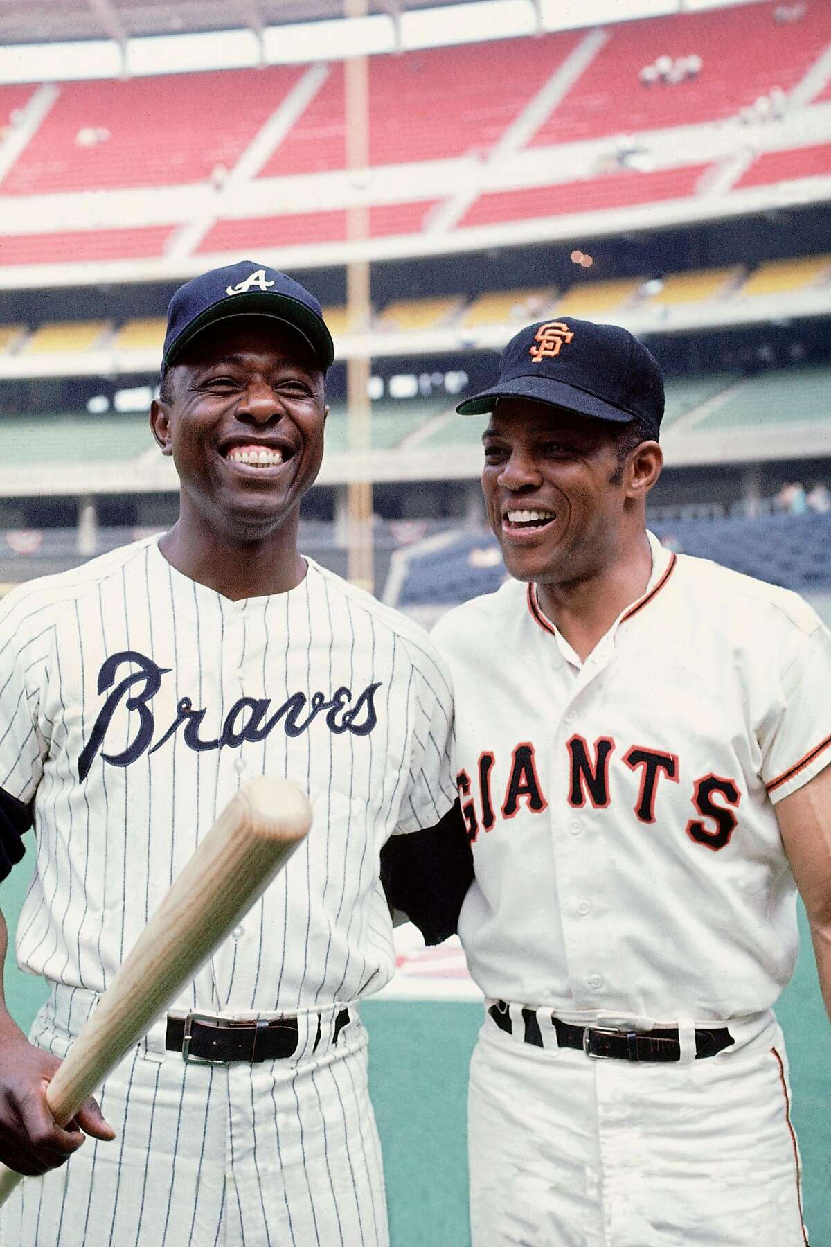 Hank Aaron (left) and Willie Mays — perhaps the two greatest players ever — share a laugh before the 1970 All-Star Game.