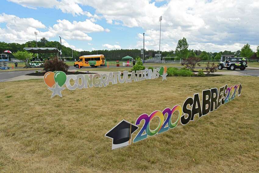 Graduates pick up their diplomas during a drive through graduation at Schalmont High School on Friday, June 19, 2020 in Rotterdam, N.Y. (Lori Van Buren/Times Union)