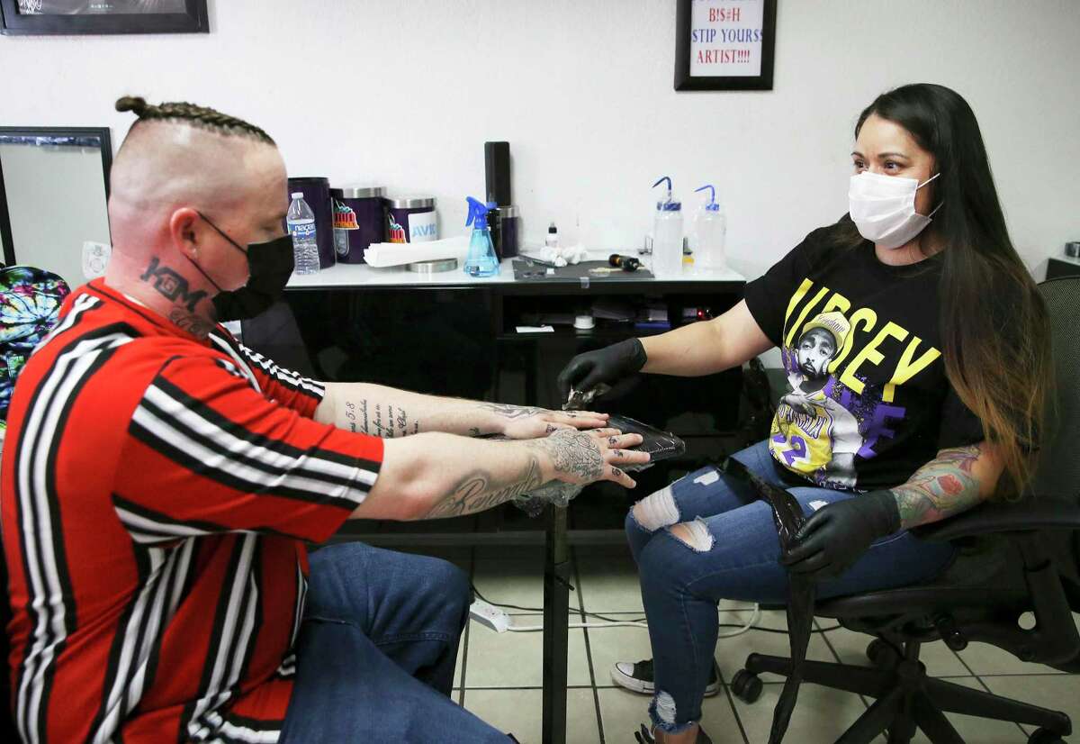 Tattoo artist Gloria Moran works at Ground Zero Tattoos in Killeen, near Fort Hood on Friday. Nationwide protests by Black Lives Matter have renewed a call to rebrand the 10 Army posts named for Confederate generals, including Fort Hood. The debate has sharpened within the military, but Moran does not believe renaming Fort Hood will change racism.