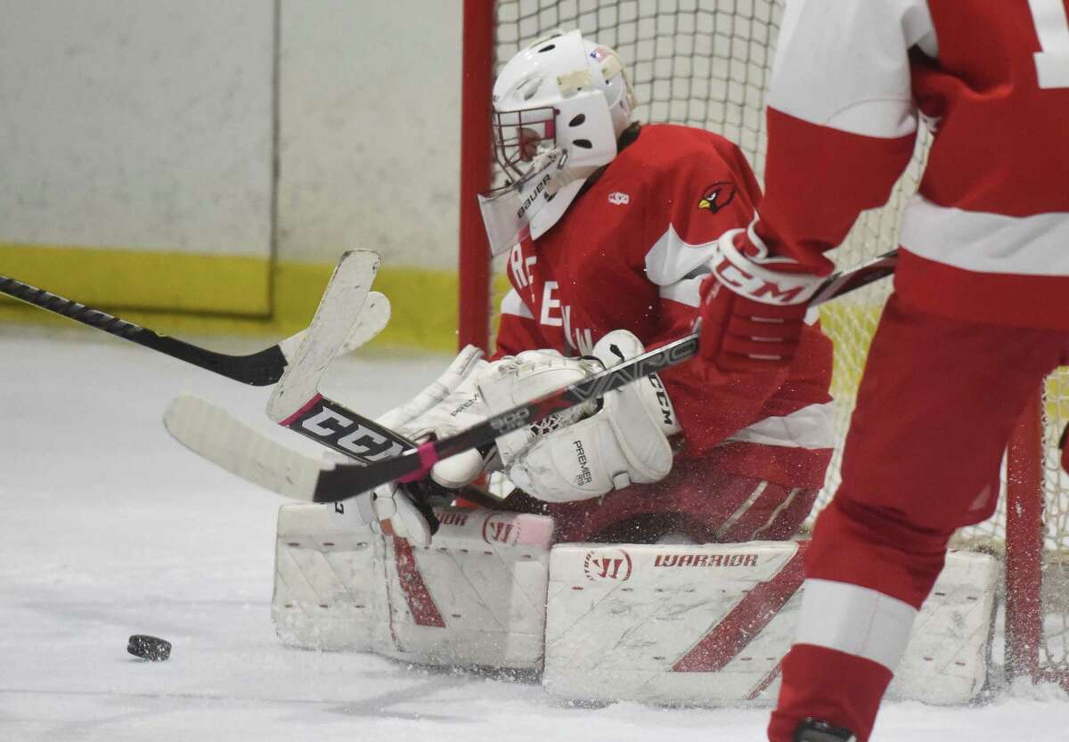 Greenwich goalie Charlie Zolin goes low to make a save during the FCIAC tournament semifinals at the Darien Ice House in 2019.
