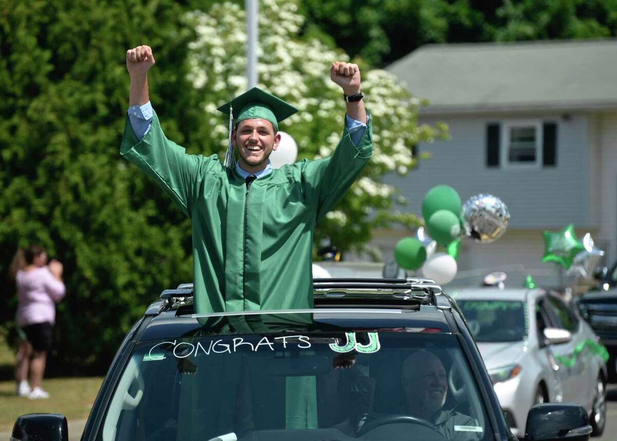 Graduate Justin Michael Jennings arrives at the 2020 New Milford High School graduation ceremony on Saturday. The graduates paraded from Sarah Noble Intermediate School to the high school and walked the sidewalk to receive their diplomas. June 20, 2020, in New Milford, Conn.