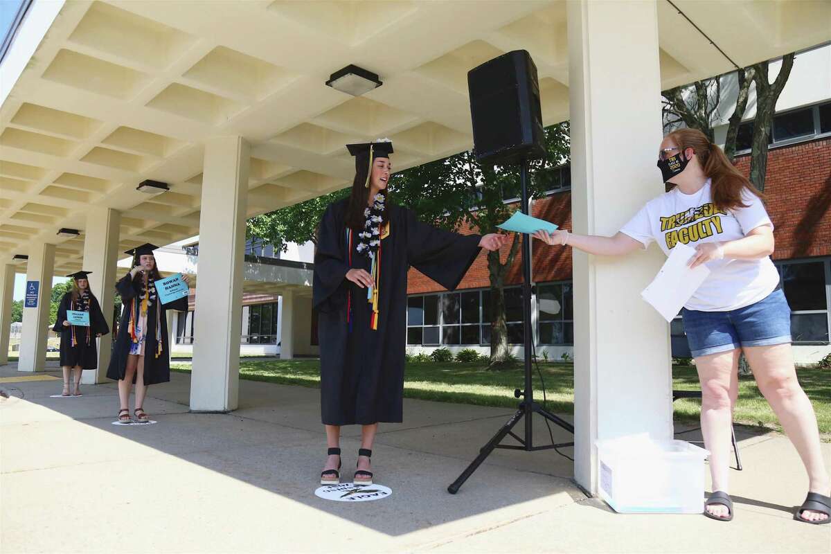 Julia Huzi stands at the front of a short line of safe-distance graduates waiting to turn their tassels at the Trumbull High School Class of 2020 graduation ceremony. Stepping out in groups of three or four, the 509 graduating seniors were then allowed to receive their diploma envelopes, turn their tassels and have a photo taken. And while seniors seemed resigned to the unusual and, to some extent, disappointing circumstances, most of them appeared to enjoy the occasion and focus their attention on the bright side.