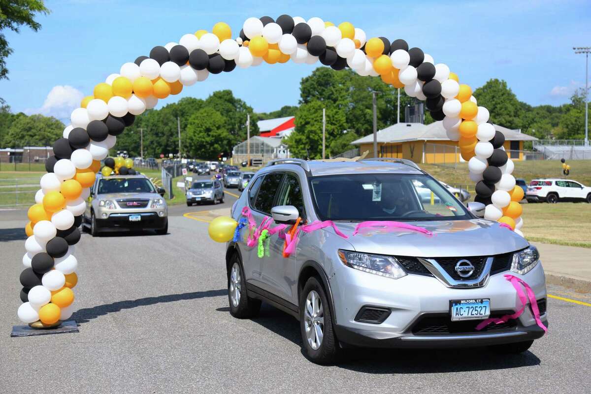 Cars pass under one of several balloon archways before students reached the staging areas to make their Trumbull High School graduation official. TRUMBULL - It wasn't the traditional ceremony, but school officials made it a memorable one when Trumbull High School's class of 2020 was graduated on Saturday. Scheduled at 90-minute intervals beginning at 9:15 a.m., groups of 30 or so vehicles - each containing a senior and their family - were directed to one of three staging areas around the school.