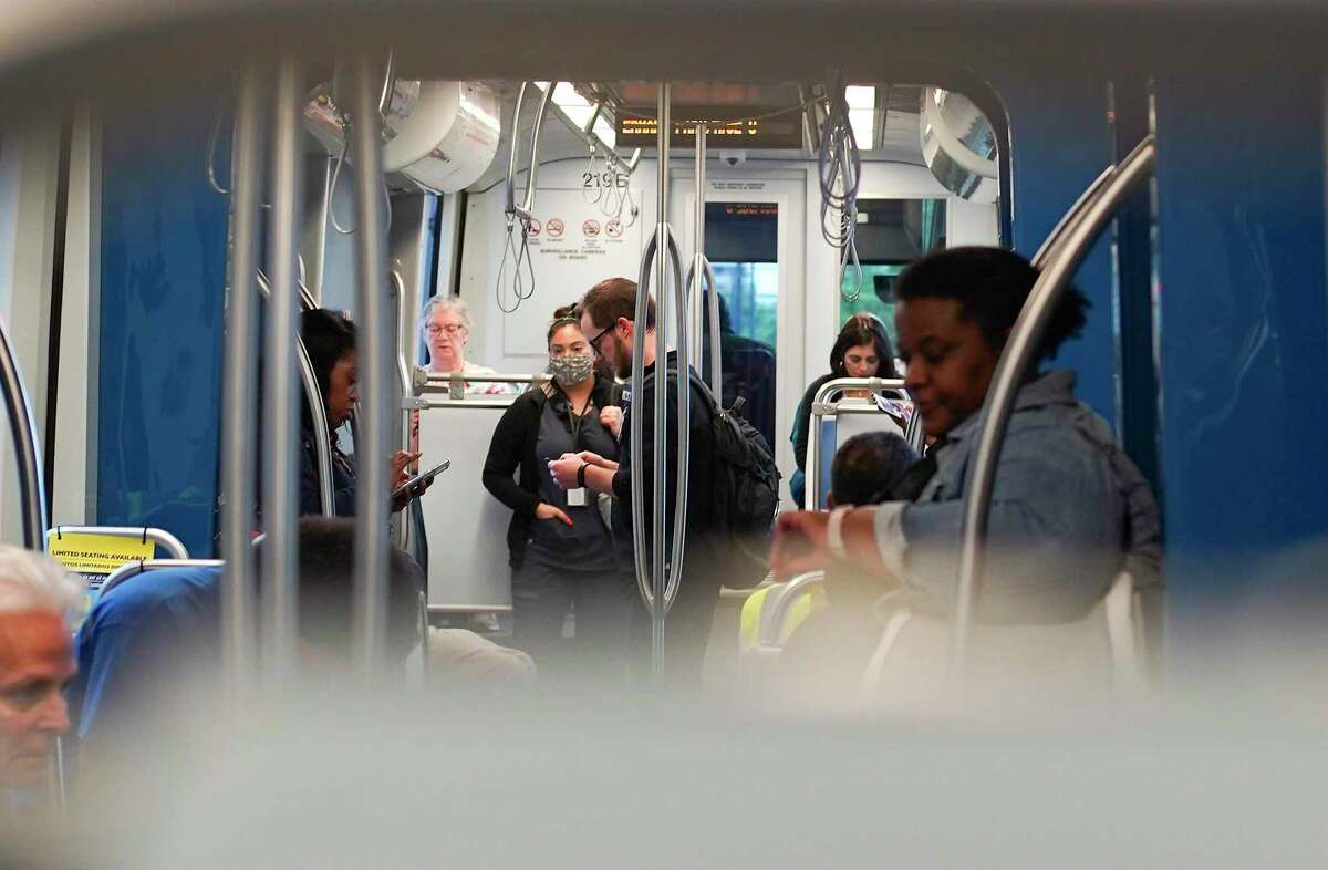 Riders take different methods for social distancing on a Metropolitan Transit Authority train March 24, 2020. Effective Thursday June 25, masks are required for all riders and Metro staff on buses and trains.