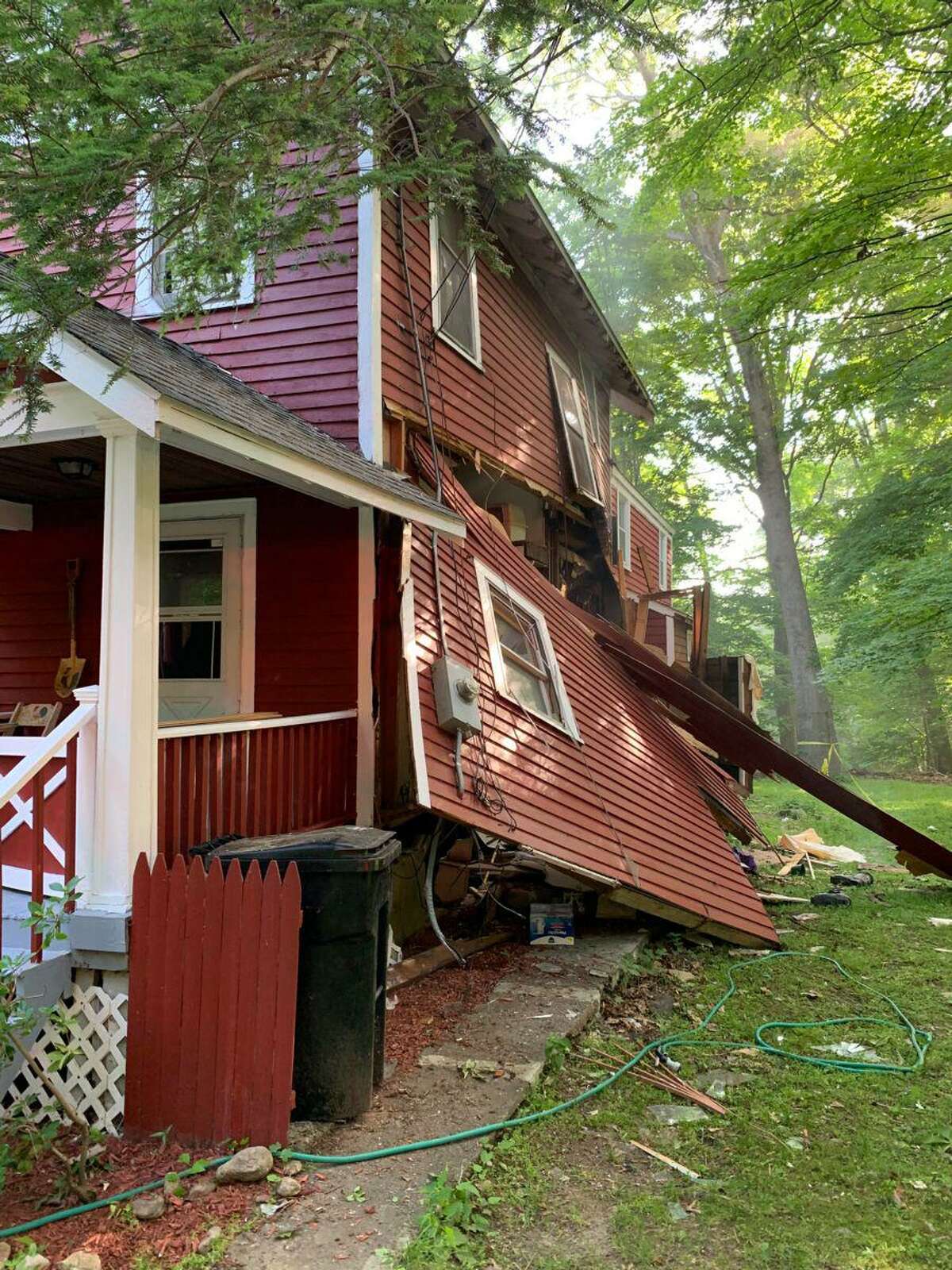 The house at 105 Woodbine Road in Stamford, Conn., partially collapsed after an explosion Saturday, June 20, 2020.