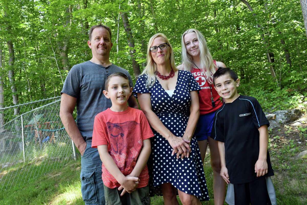Heather Kjos (center) is photographed with (clockwise from top left) her husband, Aaron, daughter, Alyssa, 17, and sons, James, 7, and Jason, 9.